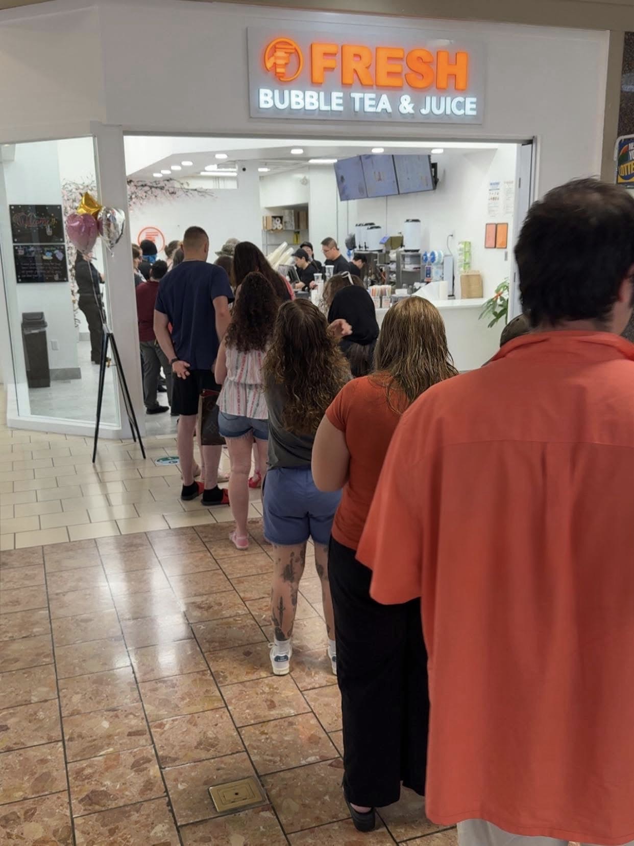 Fresh Bubble Tea & Juice storefront at Champlain Centre with a line of customers